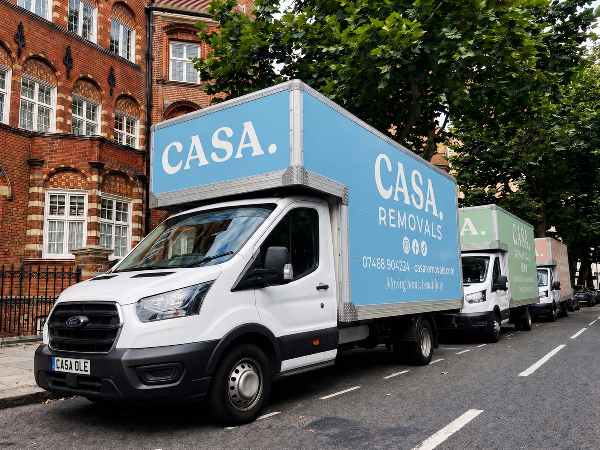 Three CASA. Removals vans lined up on a London street
