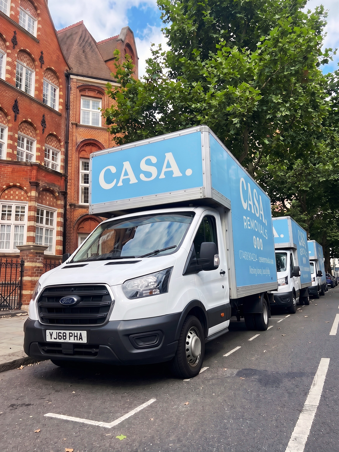 Three CASA. Removals vans lined up on a London street